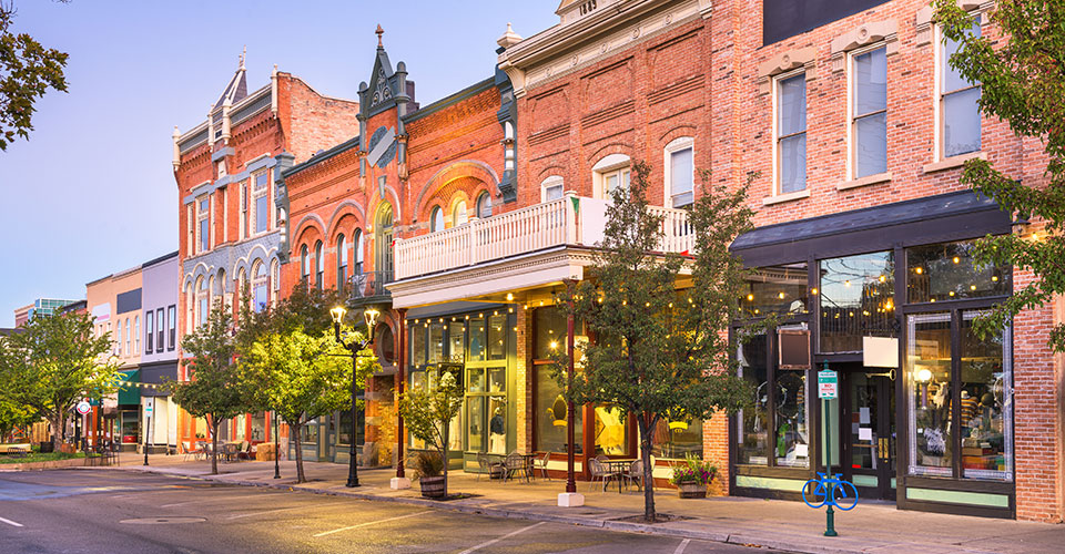 View of Main Street, parking spaces and tall brick buildings