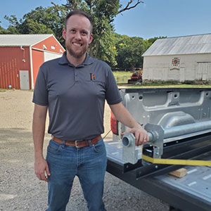 Man standing next to pickup truck, Eric Spurgeon