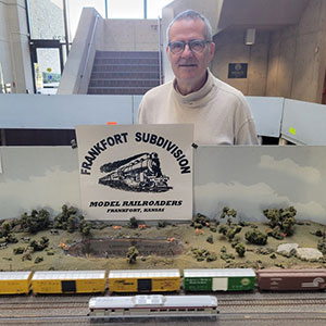 Man holding sign that reads Frankfort Subdivision model railroaders