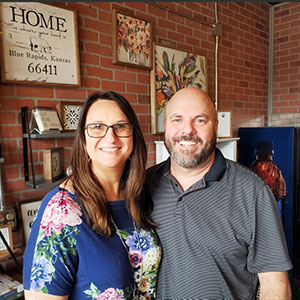 Ronna and Tony Trosper, standing inside store