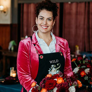 Portrait of Sara Larson holding a bouquet of flowers