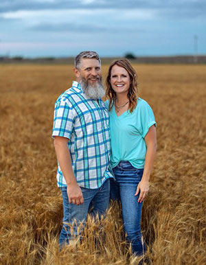 Man and woman standing in a Kansas grain field