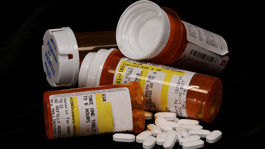 Pill bottles, opioids stacked up