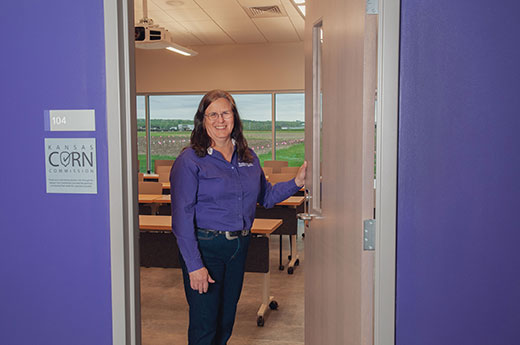 Woman standing in classroom doorway, Anita Dille