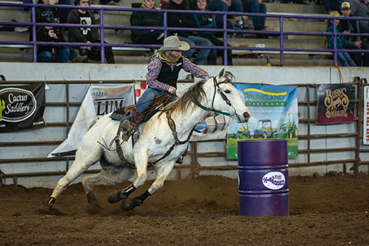 Girl on horse, barrel racing at K-State rodeo Girl on horse, barrel racing at K-State rodeo
