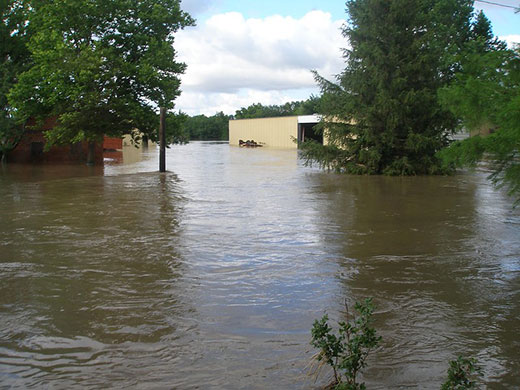 Floodwater surrounding barn and business
