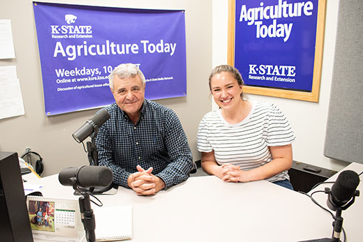 Man and woman sitting in radio studio, Eric Atkinson and Samantha Bennett